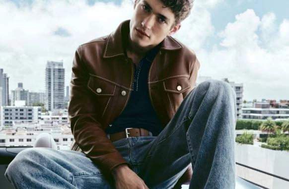 Mężczyzna w kurtce, koszulce oraz spodniach