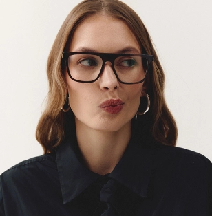 Dziewczyna w czarnej koszuli i w czarnych oprawkach okularowych